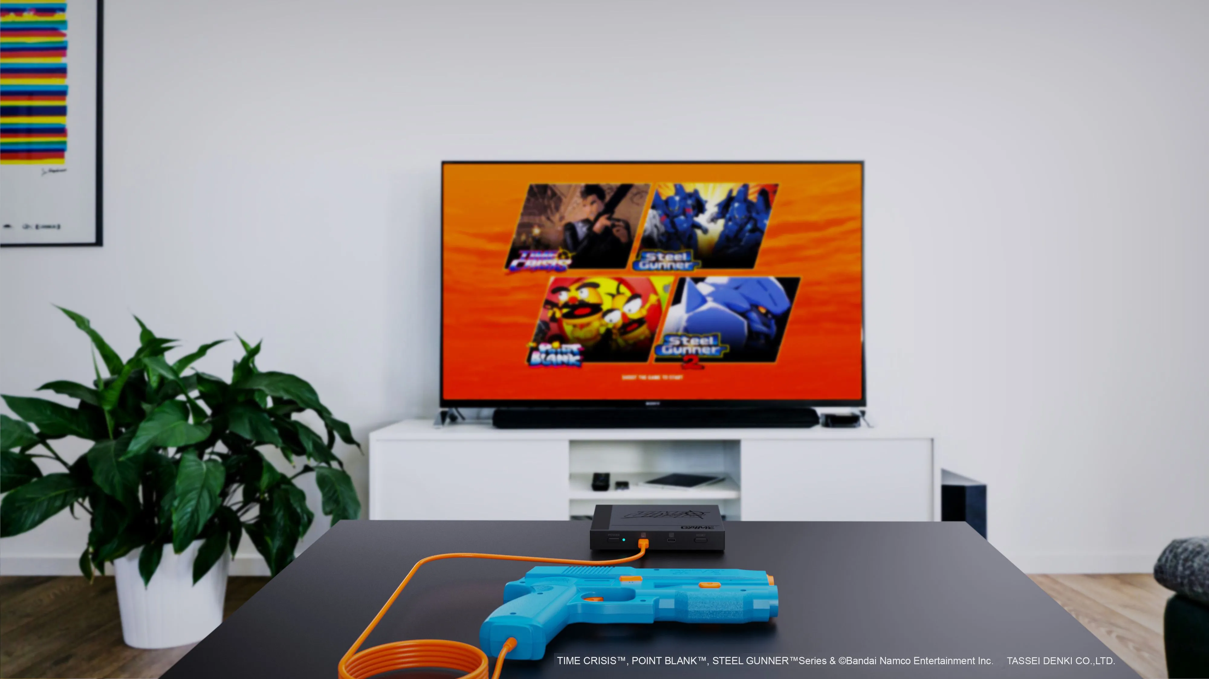 Hệ thống súng light gun G’aim’e Plug & Play đặt trước màn hình TV, sẵn sàng cho trải nghiệm game Time Crisis chân thực.