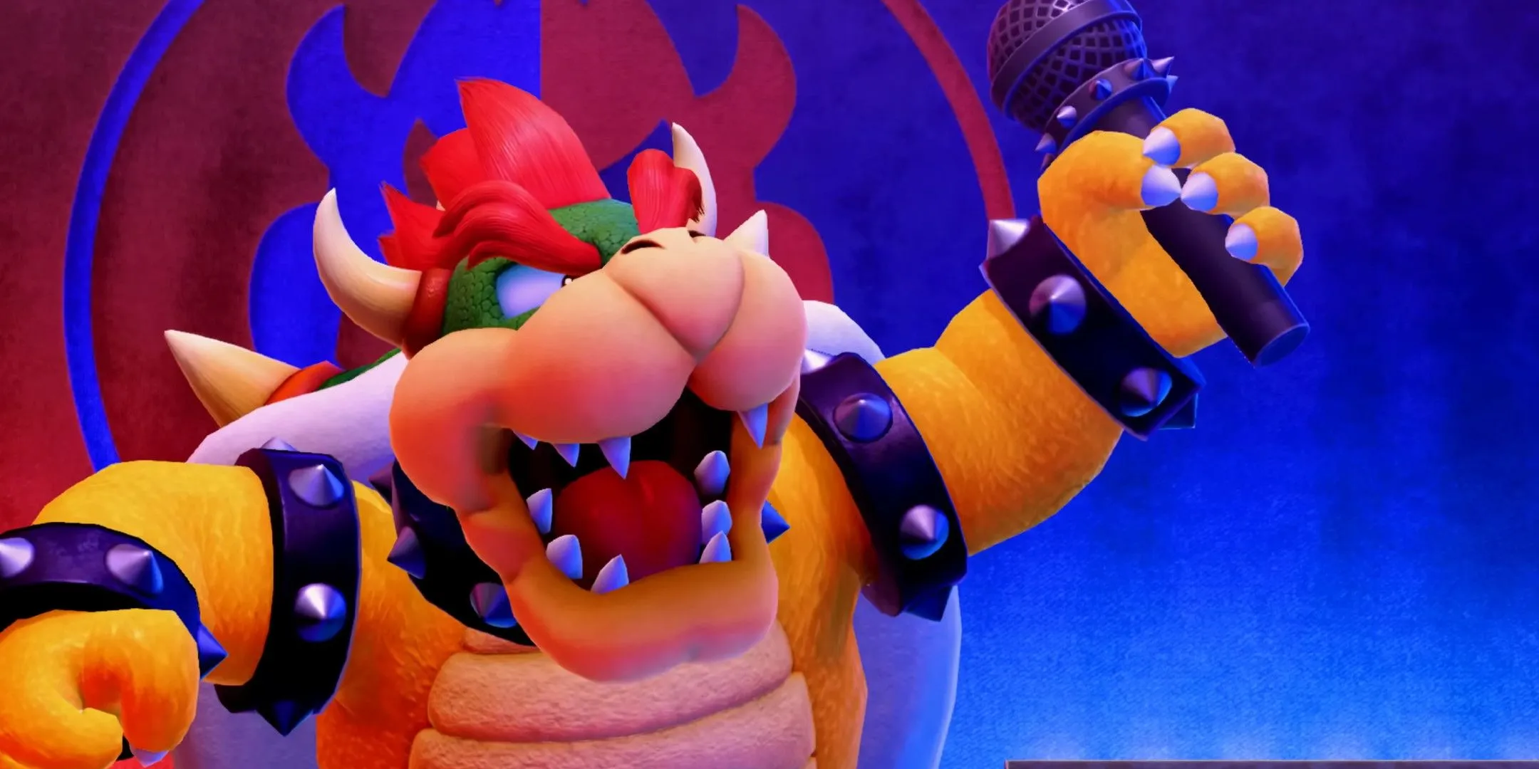 Trùm Bowser đứng trên sân khấu cầm micro